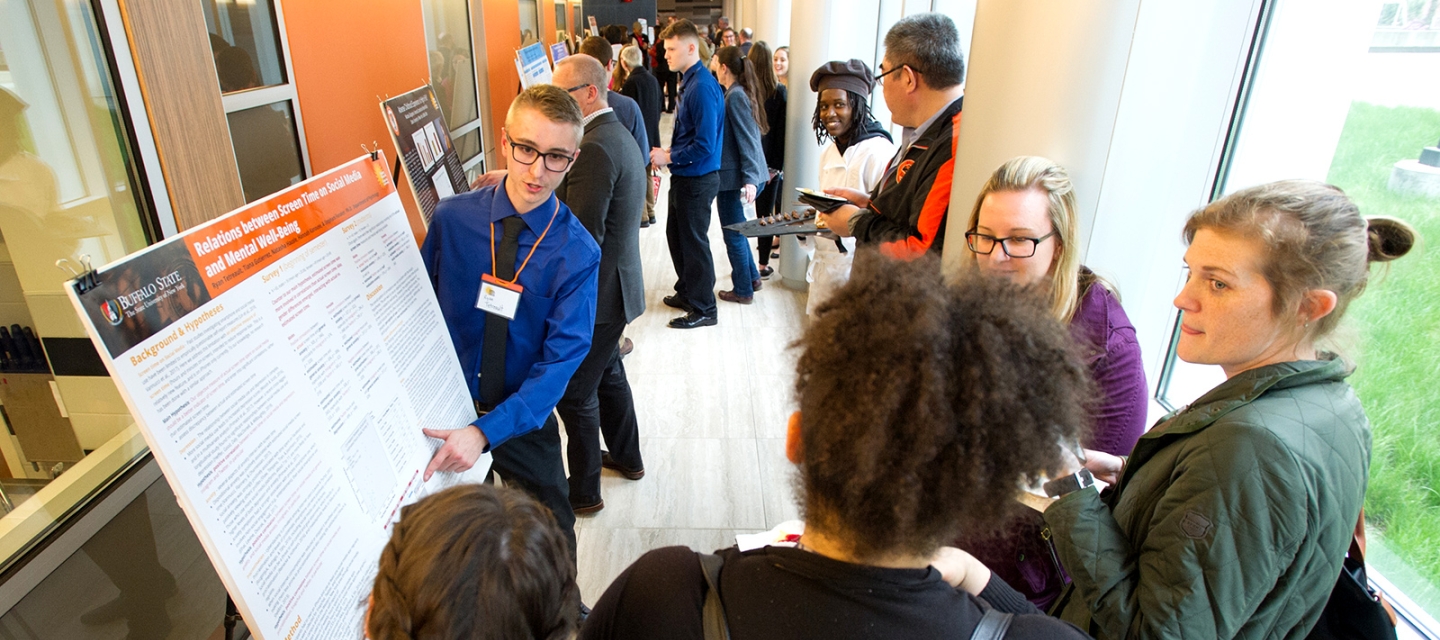 Student giving a poster presentation