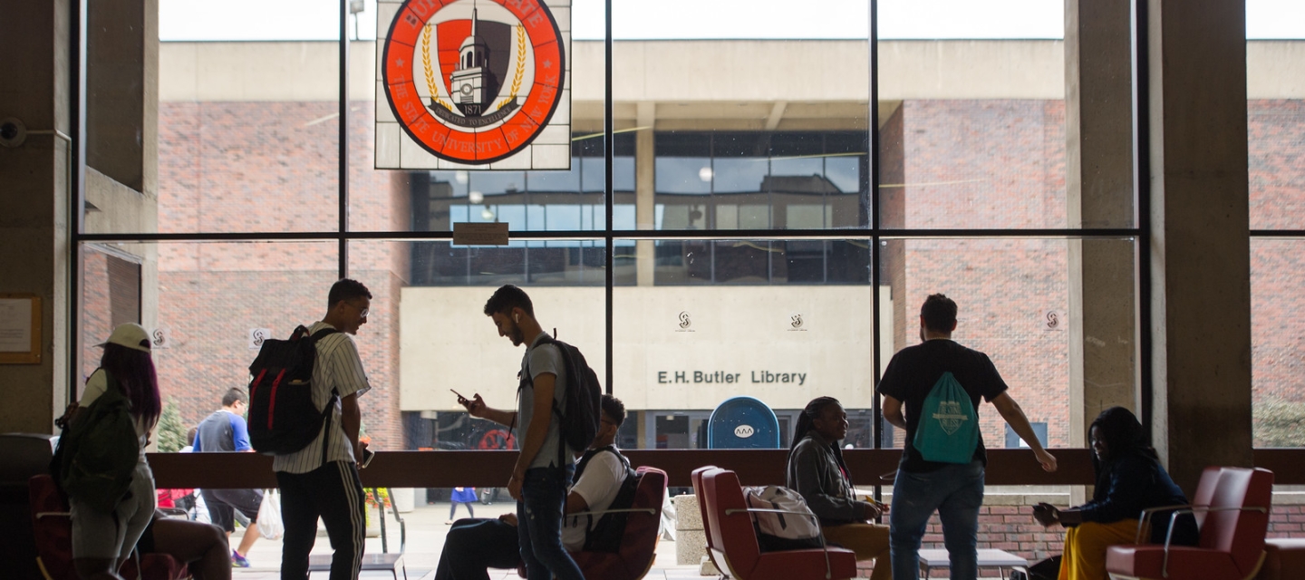 Students standing and seated in the Campbell Student Union window